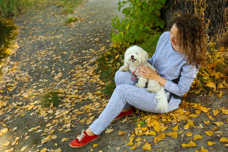Woman walking with cute dog in park