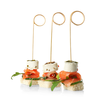 Set of delicious canapes isolated on whiteの写真素材