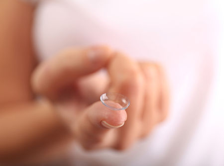 Contact lens on female finger, close up view. Medicine and vision conceptの写真素材