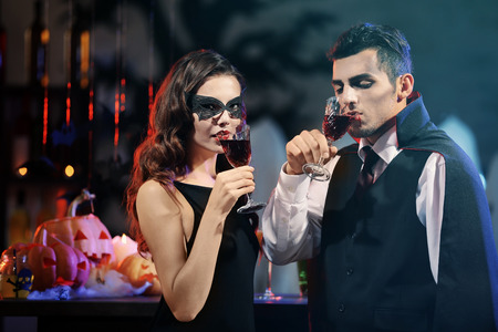 Young people dressed as vampires drinking cocktails at Halloween partyの写真素材
