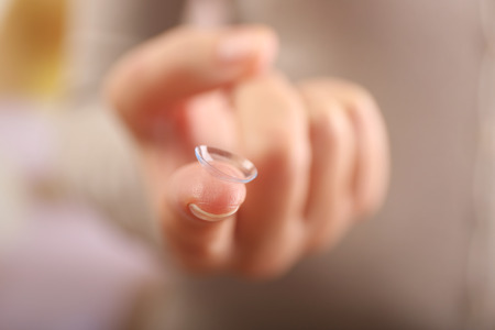 Contact lens on female finger, close up view. Medicine and vision conceptの写真素材