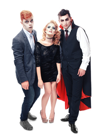 Young people dressed in different costumes for Halloween, isolated on whiteの写真素材