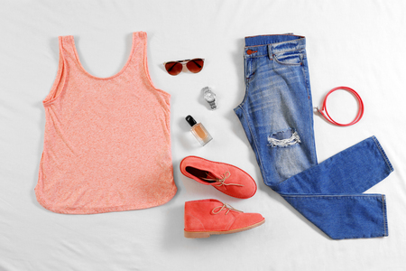 Modern clothes on bedの写真素材