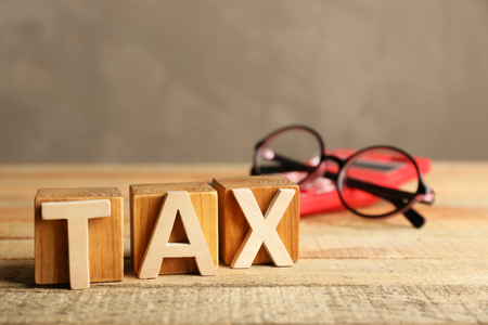 Tax concept with glasses and calculator on light backgroundの写真素材