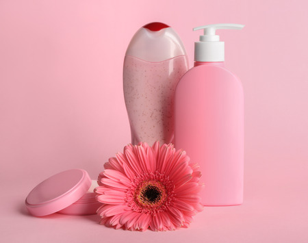Spa concept. Cosmetic products and beautiful flower on pink backgroundの写真素材