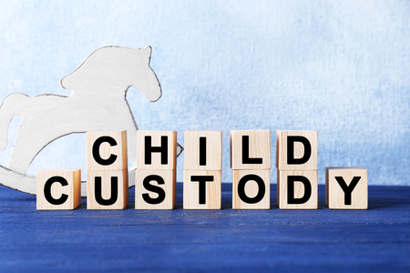 Cubes with text CHILD CUSTODY and toy on light backgroundの写真素材