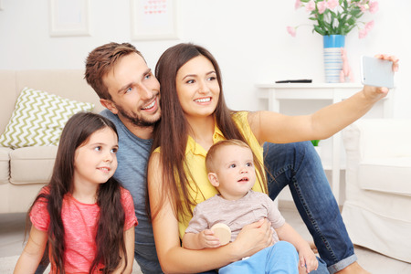 Happy family taking selfie at home