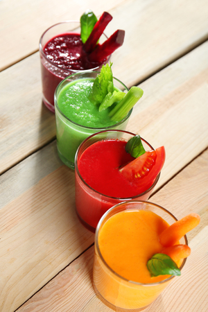 Glasses with fresh vegetable smoothie on wooden tableの写真素材