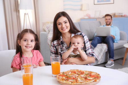 Happy family eating food on kitchenの写真素材