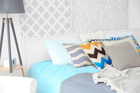 Interior of modern bedroom with cozy double bed