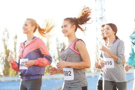 Sportsmen running at stadiumの写真素材
