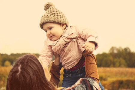 Happy mother with child outdoors in autumn dayの写真素材