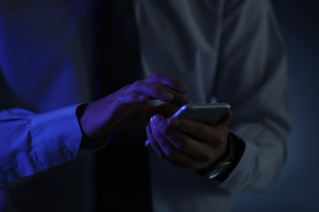 Businessman using phone, closeupの写真素材