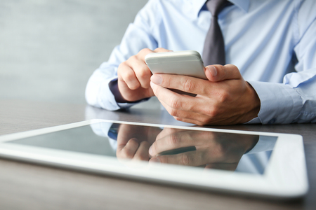 Businessman using phone  on tableの写真素材