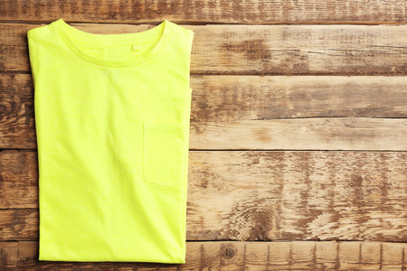 Blank color t-shirt on wooden backgroundの写真素材