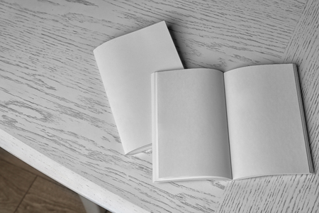 Blank brochures on wooden tableの写真素材