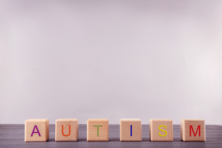Wooden cubes with word AUTISM on light backgroundの写真素材
