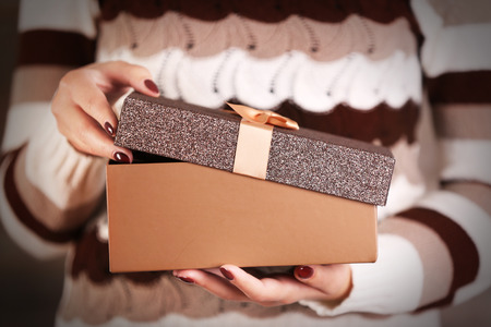 Woman holding Christmas gift, closeup