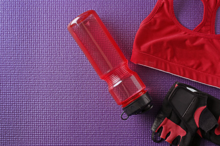 Clothes and items for sport on color backgroundの写真素材