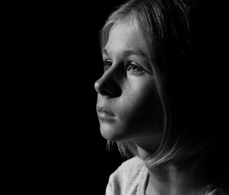 Black-and-white photo of sad little girlの写真素材
