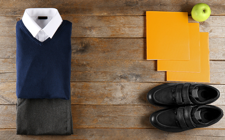 School uniform on wooden background, flat layの写真素材