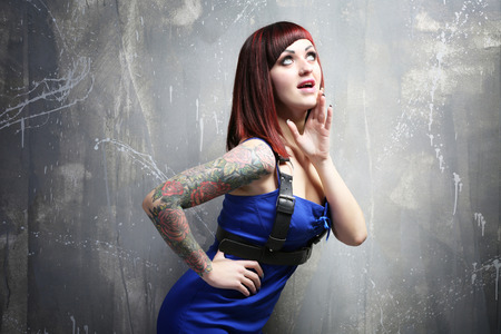 Beautiful girl with tattoo on color backgroundの写真素材