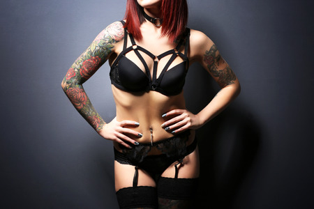 Beautiful girl with tattoo in black lingerieの写真素材