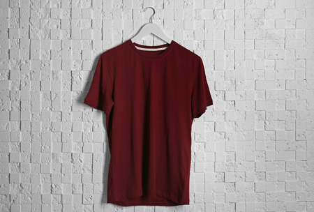 Blank maroon t-shirt against light textured backgroundの写真素材