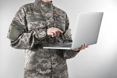 Soldier holding laptop. Military education conceptの写真素材