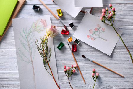 Different drawings of flowers on wooden backgroundの写真素材