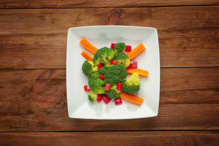 Plate with fresh vegetables on wooden backgroundの写真素材