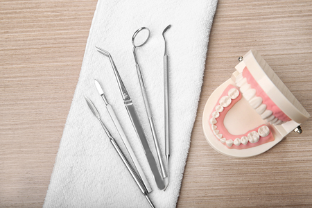 Dental jaw model and tools on wooden backgroundの写真素材