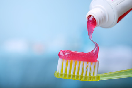 Toothpaste squeezed from tube onto brush, close up