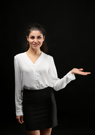 Young businesswoman on black backgroundの写真素材