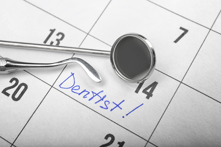 Word DENTIST in calendar and dental tools, closeupの写真素材