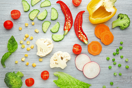 Fresh vegetables on wooden background, top viewの写真素材