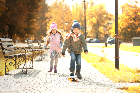 Cute children skateboarding in parkの写真素材