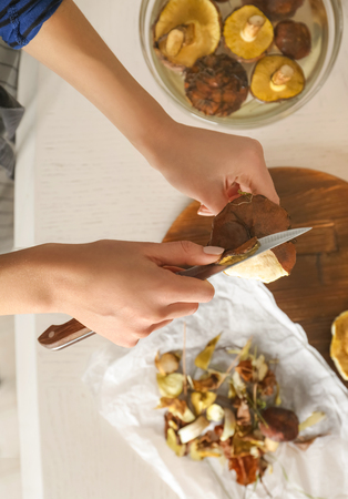 Woman preparing mushrooms at kitchen, closeupの写真素材