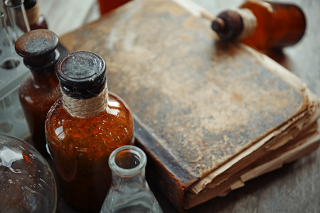 Old book with glass bottles, closeupの写真素材