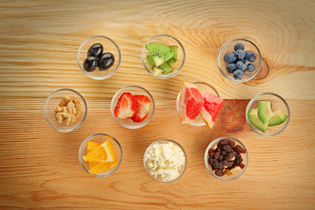 Healthy eating concept. Assortment of products in bowls on wooden backgroundの写真素材