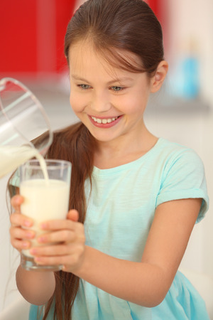 Cute girl with glass of fresh milkの写真素材