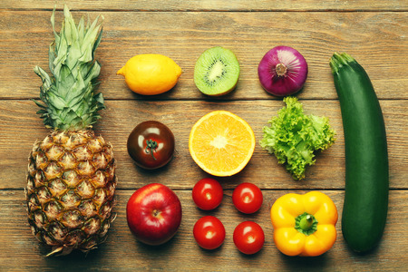 Colourful fruits and vegetables on wooden backgroundの写真素材