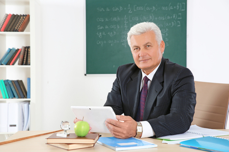 Senior teacher at lesson in classroomの写真素材