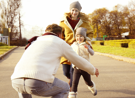 Happy family having fun in autumn parkの写真素材