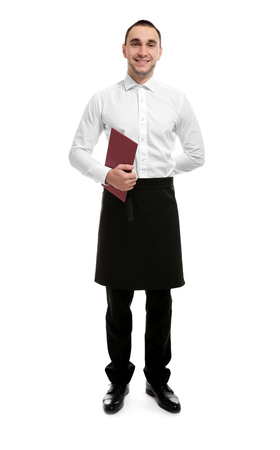 Young handsome waiter holding restaurant menu on white backgroundの写真素材