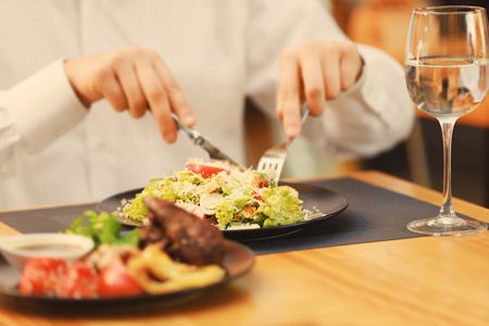 Client eating tasty Caesar salad in restaurant, close upの写真素材