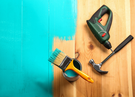 House renovation tools on turquoise painted wooden background