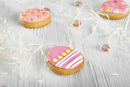 Creative Easter cookies and decorations on wooden table, closeup