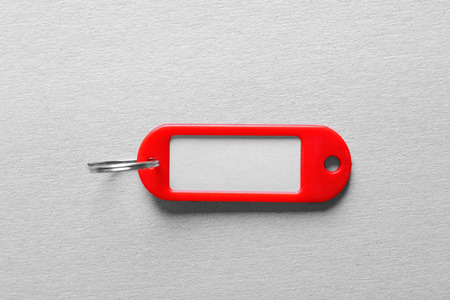 Red key tag on light backgroundの写真素材