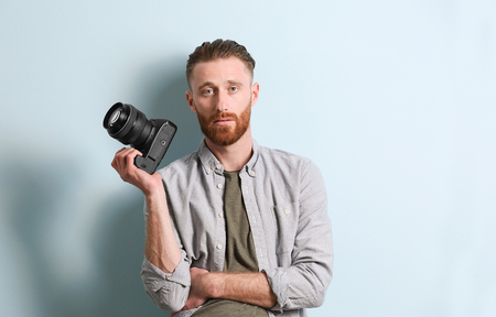 Handsome photographer on color backgroundの写真素材